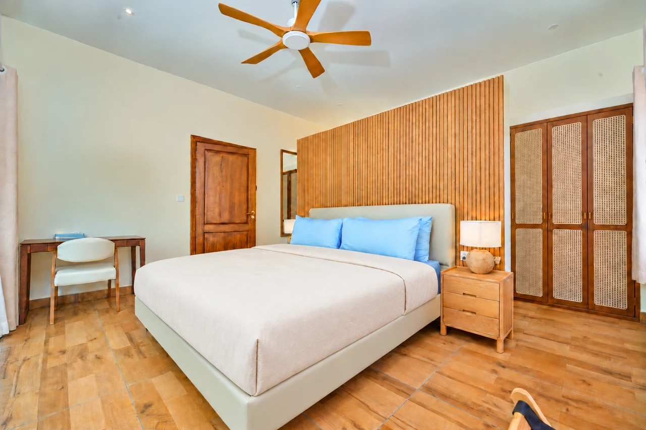 A king bedroom with wood and cane details