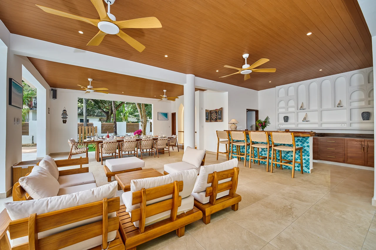The Pavilion lounge, dining table and bar beside the pool