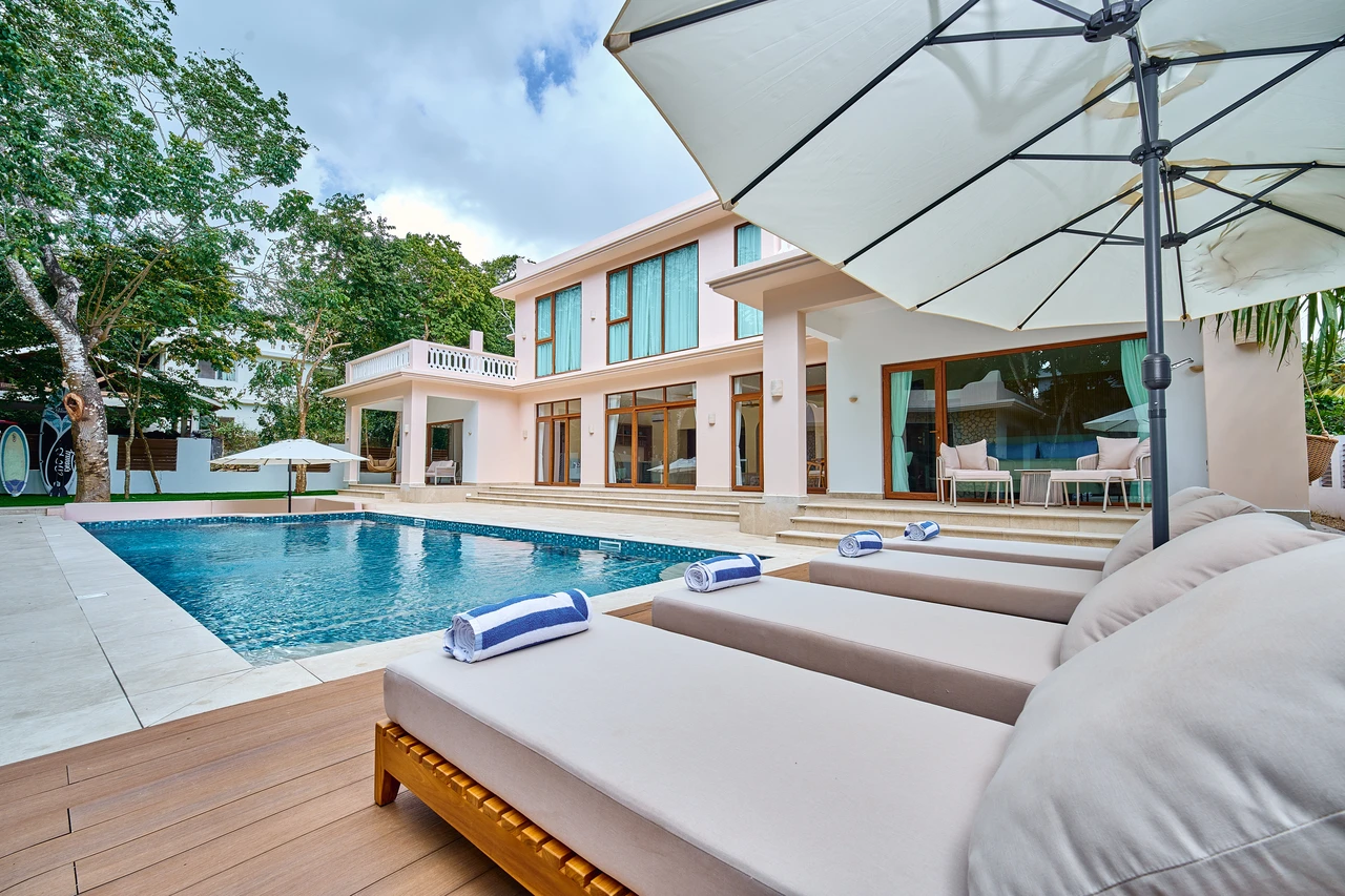 The villa pool viewed from a shaded lounger