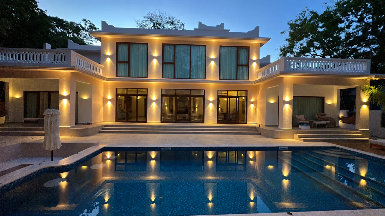 The Aría at dusk, with warm villa lights reflected in the pool