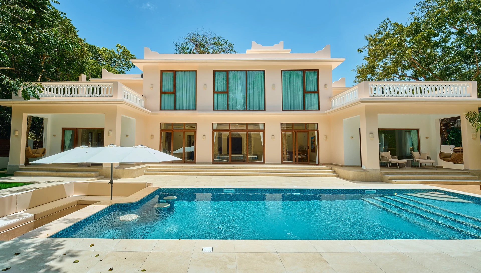 The Aría villa and private swimming pool framed by tropical trees